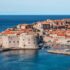 white and red concrete houses beside sea